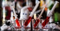 creepy halloween party cocktails with syringes of grenadine syrup as blood, shot drinks at party