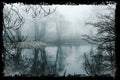 A creepy lake in the woods on a foggy morning