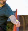 Creepy man with a beard offering candy lollipop to children on a playground