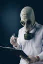 A scary doctor in gas mask holding a pen and clipboard Royalty Free Stock Photo