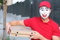 Creepy pizza delivery worker wearing a mask