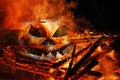 A creepy pumpkin head in the fire