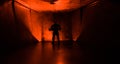 Creepy silhouette in the dark abandoned building. Horror about maniac concept or Dark corridor with cabinet doors and lights with Royalty Free Stock Photo