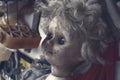 Creepy sinister old broken dirty abandoned doll as halloween concept