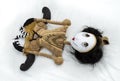 Creepy steampunk doll lying on back with legs tucked.