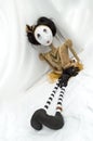 Creepy steampunk doll sitting with legs outstretched. Vertical. Tilted.