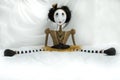 Creepy steampunk doll sitting with legs wide apart.