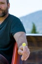 Creepy man with a beard offering candy lollipop to children on a playground