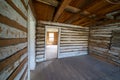 Creepy, vacant spooky interior of an abandoned log cabin in Bannack Ghost Town in Montana Royalty Free Stock Photo