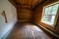 Creepy, vacant spooky interior of an abandoned log cabin in Bannack Ghost Town in Montana