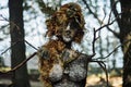 Creepy witch statue art object on forest background made of mud plaster and dry grass gloomy statue