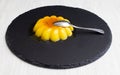 A crem caramel in a slate plate and dried fruit