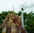 Crematorium and smoke with green tree background and white cloudy feel so sad at Wat Cheung Hawaii, Pitsanulok,north of Thailand.