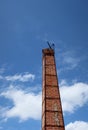 Crematorium smokestack in Thai temple, orange brick, sky background, selectable focus, funeral concept. Royalty Free Stock Photo