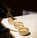 Creme brulee final incrustation preparation in the kitchen Royalty Free Stock Photo