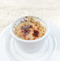 Creme brulee on white porcelein cup.