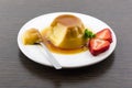 Creme caramel vanilla custard dessert or flan on white dish with Royalty Free Stock Photo