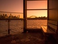 Cremorne Point Wharf at the waterfront with beautiful Sydney harbor sunset scenery in the background.