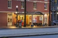 The Creole House Restaurant and Oyster Bar on Canal Street with people standing outside, cars driving on the street