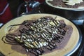 Crepe banana chocolate top almond on hot pan Royalty Free Stock Photo