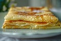 Crepe stack on a white plate, a light and fluffy breakfast option perfect for any day
