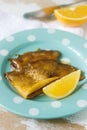 Crepe suzette in caramel sauce on a plate with a slice of orange. French dessert. Royalty Free Stock Photo