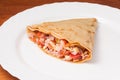 Crepe with tomatoes ham and cheese on a white plate Royalty Free Stock Photo