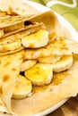 Crepes with banana, maple syrup and sugar powder