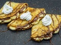 Crepes with banana slices and chocolate served on slate Royalty Free Stock Photo