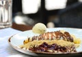 Crepes with chocolate cream, copy space. Pancakes with chocolate paste, hazelnuts, cherry sauce and a scoop of ice cream on a Royalty Free Stock Photo