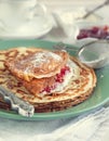 Crepes with cream cheese and strawberry jam. Royalty Free Stock Photo