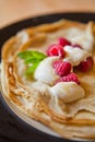 Crepes with cream and raspberry