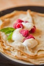 Crepes with cream and raspberry