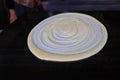 Crepes dough with spiral on black background