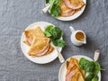 Crepes with ham and spinach. Delicious, nourish breakfast on a grey background Royalty Free Stock Photo