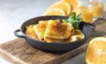 Crepes with Orange Sauce in a cast iron pan. Traditional French crepe Suzette with orange sauce Royalty Free Stock Photo