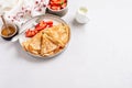 Crepes pancakes with cream cheese and fresh strawberry in beautiful white ceramic plate. Space for text or recipe. Top view Royalty Free Stock Photo