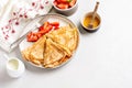 Crepes pancakes with cream cheese and fresh strawberry in beautiful white ceramic plate. Space for text or recipe. Top view Royalty Free Stock Photo