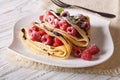 Crepes with raspberry berries and chocolate close-up