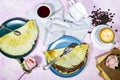 Crepes stuffed with chocolate spread on blue plate with fig jam bowl and late art coffee, beans and old book with rose flowers Royalty Free Stock Photo