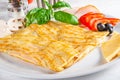 Crepes stuffed with mushrooms, ham, chicken and cheese on white plate Royalty Free Stock Photo