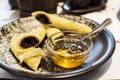 Crepes stuffed with poppy seeds, nuts and honey on plate for breakfast. Delicious pancakes wrapped with poppy seeds Royalty Free Stock Photo