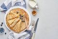 Crepes, thin pancakes or blini with berries in white plate. Top view. Pancake week. Shrovetide. Space for text