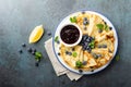 Crepes, thin pancakes with blueberry jam and fresh berries with lemon zest Royalty Free Stock Photo