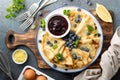 Crepes, thin pancakes with blueberry jam and fresh berries with lemon zest Royalty Free Stock Photo