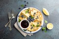 Crepes, thin pancakes with blueberry jam and fresh berries with lemon zest Royalty Free Stock Photo