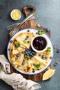 Crepes, thin pancakes with blueberry jam and fresh berries with lemon zest Royalty Free Stock Photo