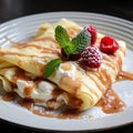 Crepes or thin pancakes with cream cheese, fresh raspberries and caramel on a white , close up Royalty Free Stock Photo