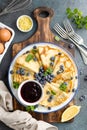 Crepes, thin pancakes with fresh tangerine slices, pecan nuts, syrup and whipped cream