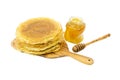 Crepes on a white background with a jar of honey. Kitchen concept